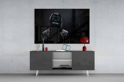 Modern living room setup with gray media console displaying neon-masked figure artwork on mounted TV and red decorative accessories.