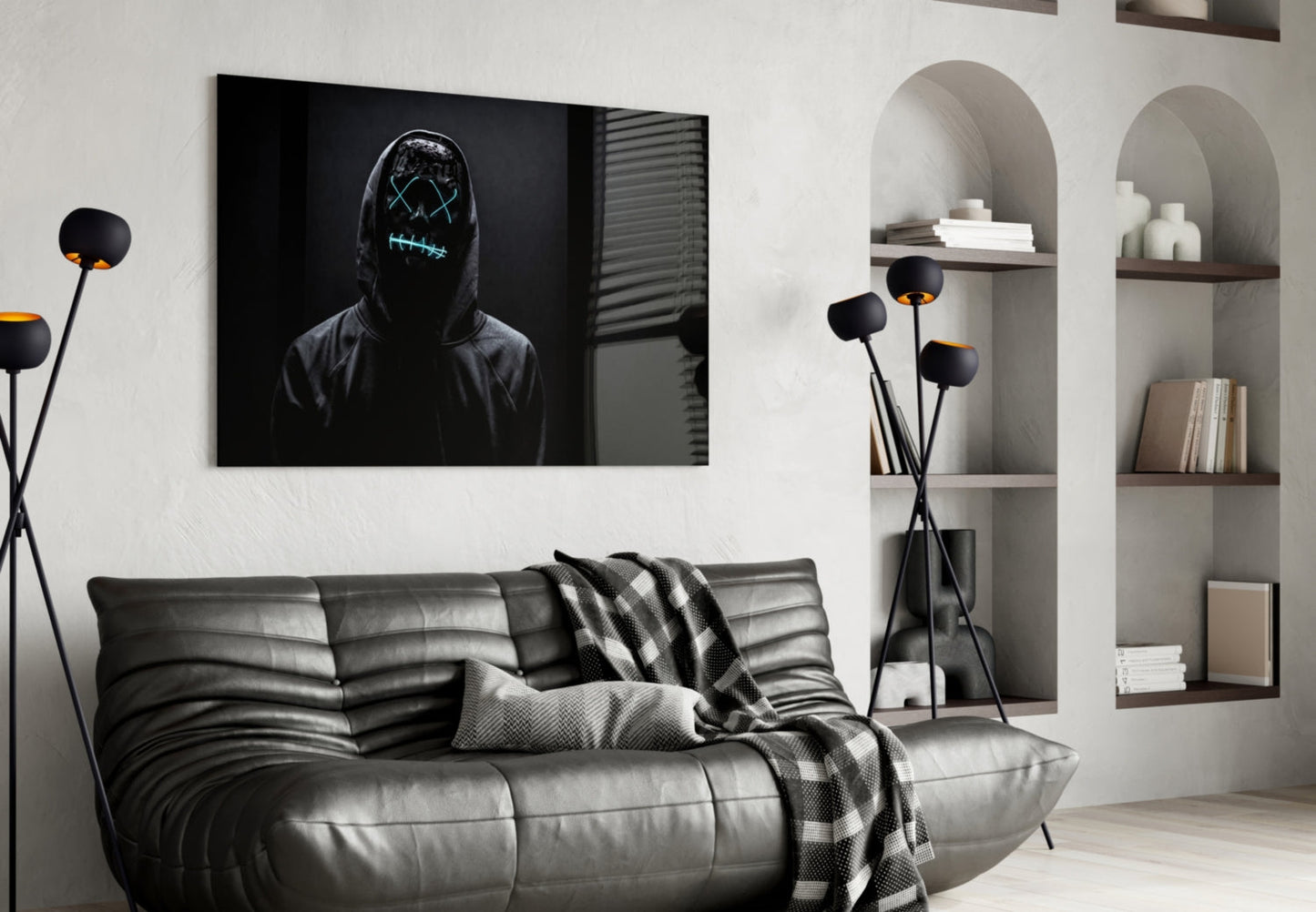 Modern living room with black leather sofa, neon-masked figure artwork above, and white arched shelving with decorative items.
