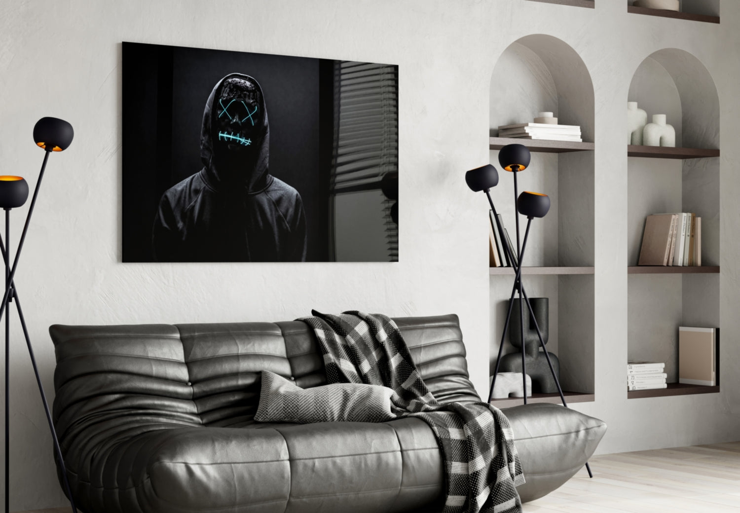 Modern living room with black leather sofa, neon-masked figure artwork above, and white arched shelving with decorative items.