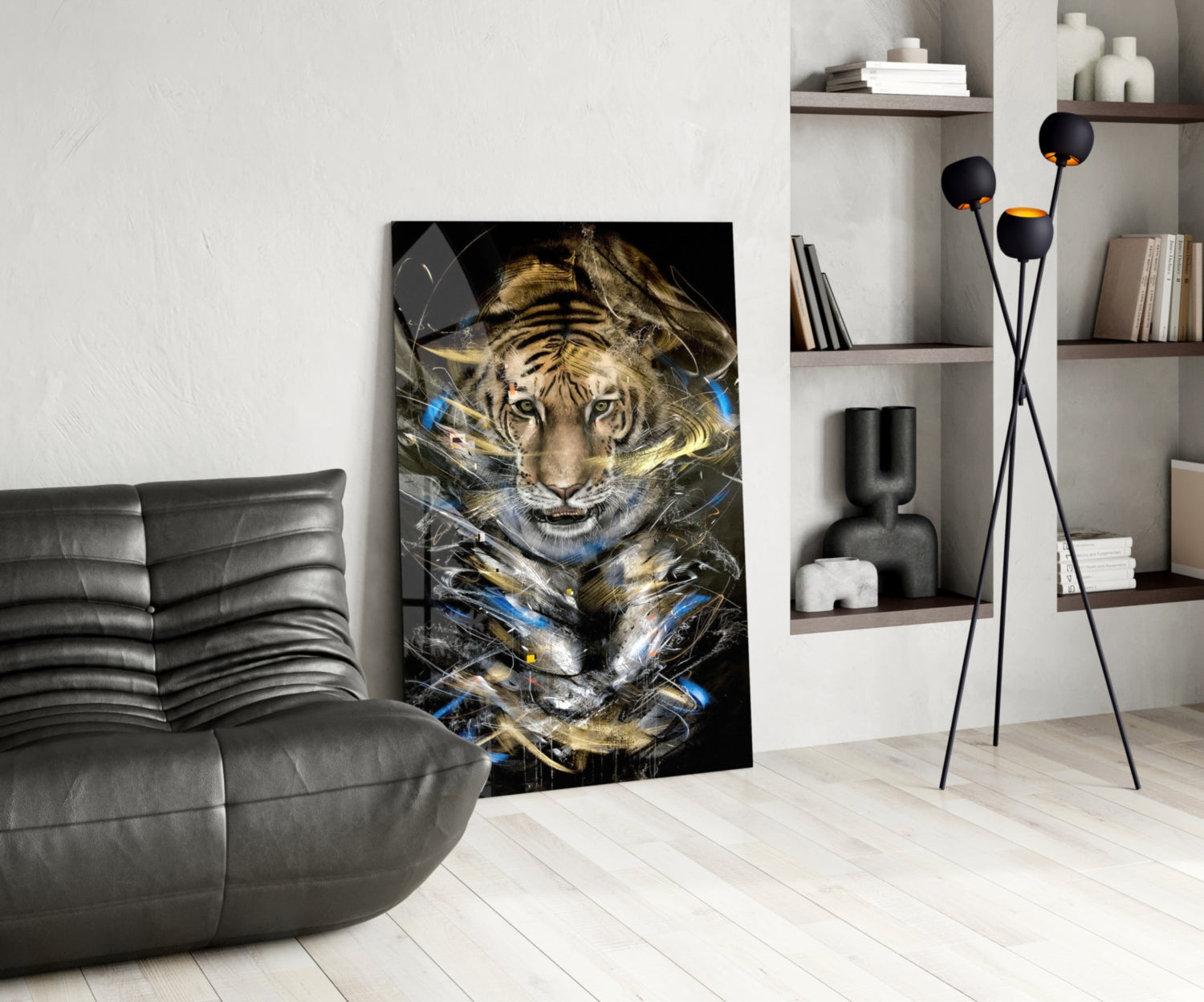 Modern living room featuring a black and gold tiger glass art panel leaning against a white wall beside a gray leather chair.