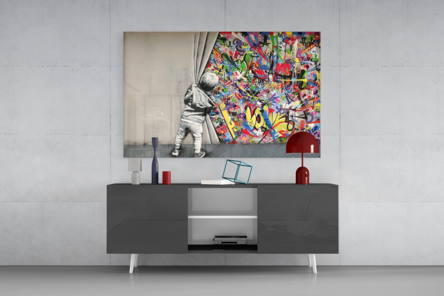 Modern living room with "Behind the Curtain" glass art print displayed above gray media console with red lamp and decorative objects.