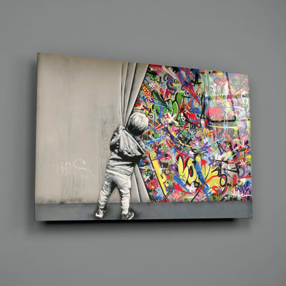 Child in monochrome pulling back curtain to reveal vibrant multicolored graffiti art on glass panel.