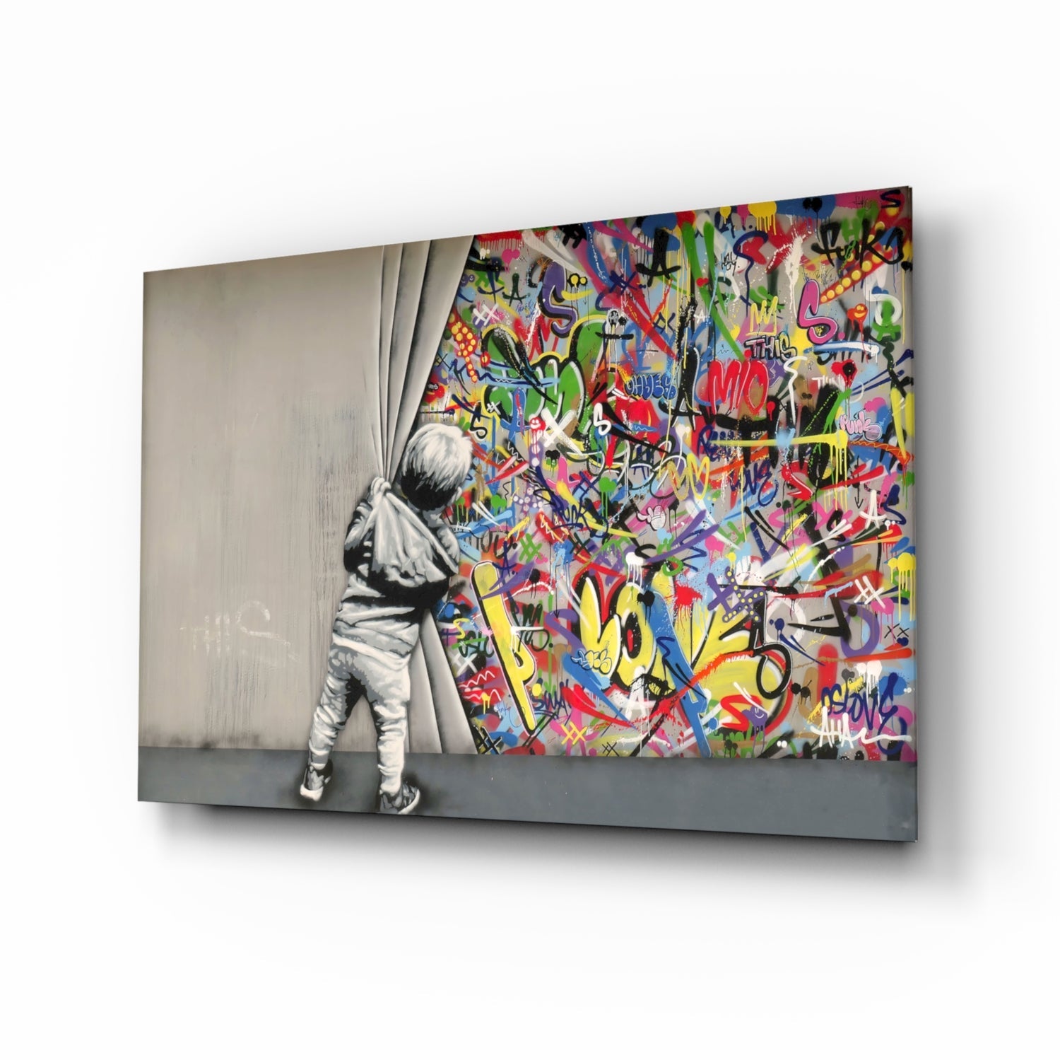 Child in grayscale pulling back curtain to reveal vibrant multicolored graffiti art on glass panel.