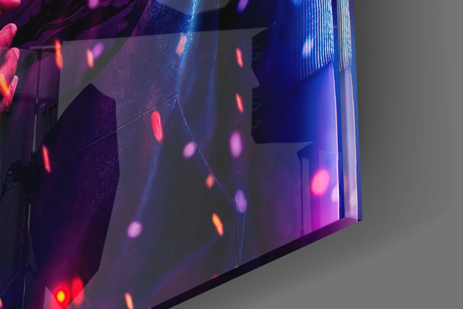 Close-up angled view of layered glass art with neon pink, blue, and red lights creating bokeh effects against gray background.