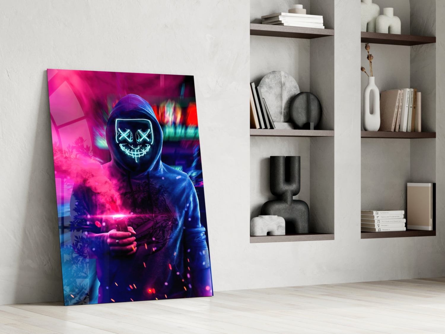 Neon Protest Glass Art leaning against white wall beside built-in shelving, displaying hooded figure with glowing cyan X-eyes and pink neon light effects.