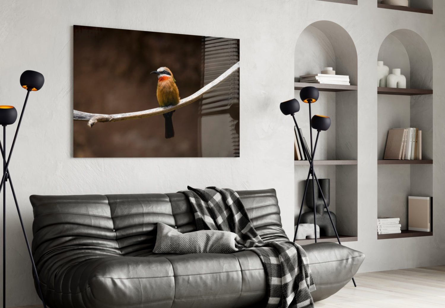 Bee Eater glass art depicting an orange and black bird perched on a branch, displayed above a black leather sofa in a modern living room.