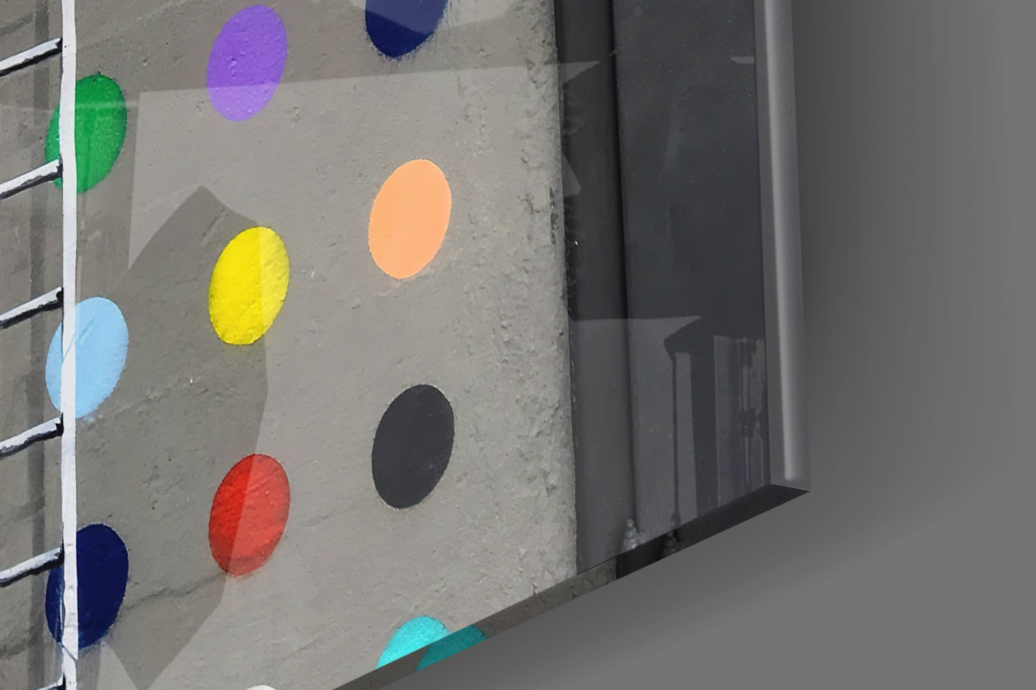 Colorful painted dots in green, blue, yellow, orange, purple, red, black, and cyan on a concrete wall with metal ladder rungs.