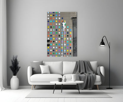 Colorful polka dot glass art panel displayed above white sofa in modern living room interior.
