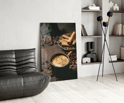 Cinnamon Coffee glass art leaning against wall in modern living room with gray sofa and shelving.