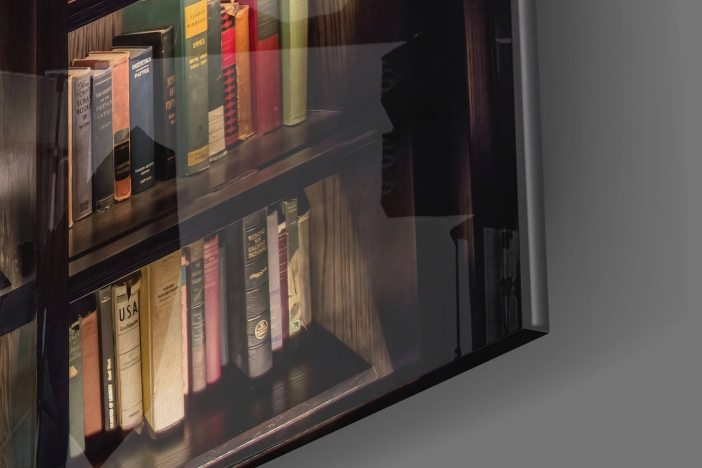 Glass-fronted display case showing two shelves of vintage books in various colors including red, green, cream, and brown leather bindings with gold lettering.