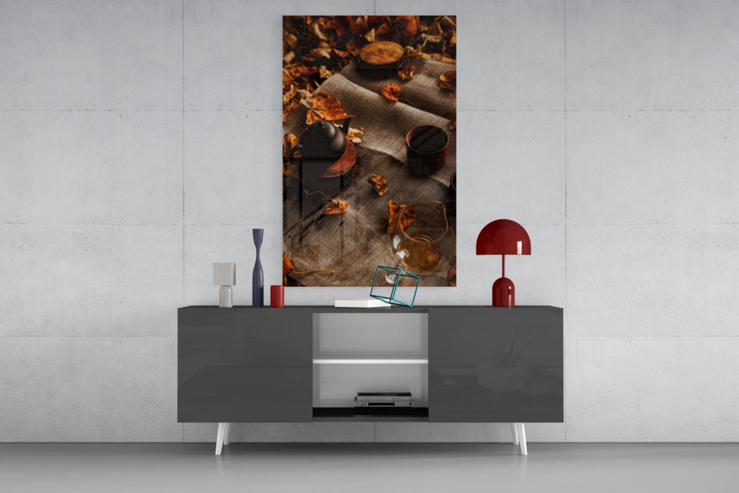 Autumn Picnic Glass Art displayed as wall art above a modern gray sideboard with decorative accessories.