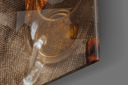 Close-up of amber glass art piece displaying warm golden tones against textured neutral fabric background.