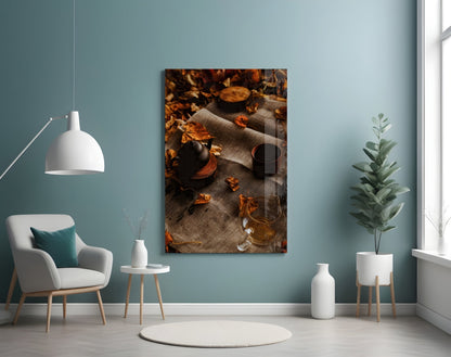 Autumn Picnic Glass Art displayed on teal wall showing styled flat lay with teapot, glass, dried leaves, and fabric.