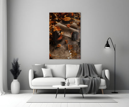 Autumn Picnic Glass Art displayed above a white sofa, showing dark bottles and scattered golden leaves on textured fabric.