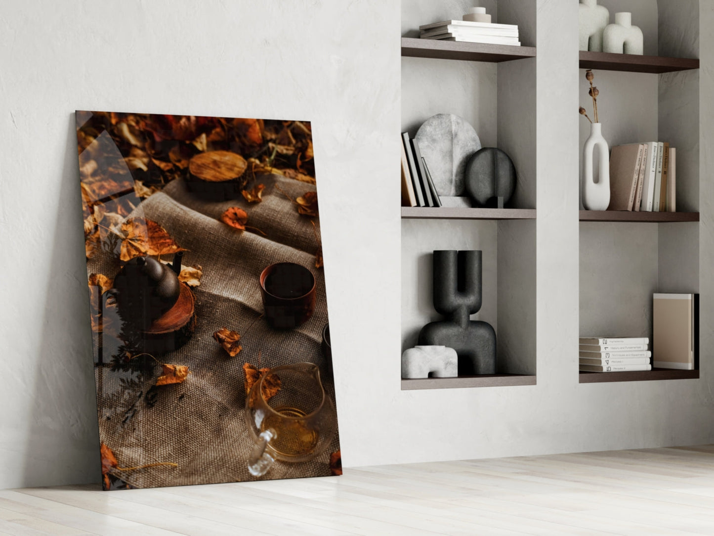 Autumn Picnic glass art leaning against white wall, displaying warm-toned overhead view of teapot, mug, and fall leaves on linen.