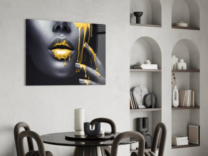 Yellow Lips Glass Wall Art displayed above black round dining table in modern interior with built-in shelving.