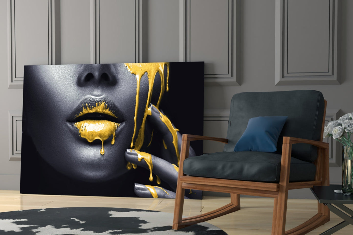 Yellow Lips Glass Wall Art displayed in a modern living room next to a wooden-framed chair, showing close-up of dripping gold paint on dark skin.
