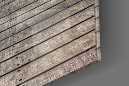 Close-up angled view of textured glass surface with horizontal grooves and small holes, showing beige and gray tones with printed text detail.