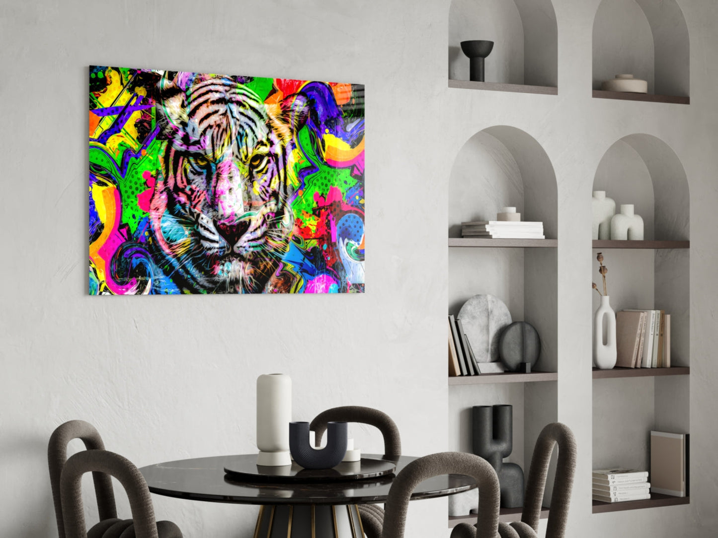Vibrant pop art tiger canvas displayed above a round black dining table with gray chairs in a modern interior with white shelving.
