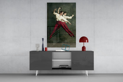 Fencing glass wall art depicting two fencers in cream shirts and red pants displayed above a gray console table with decorative accessories.