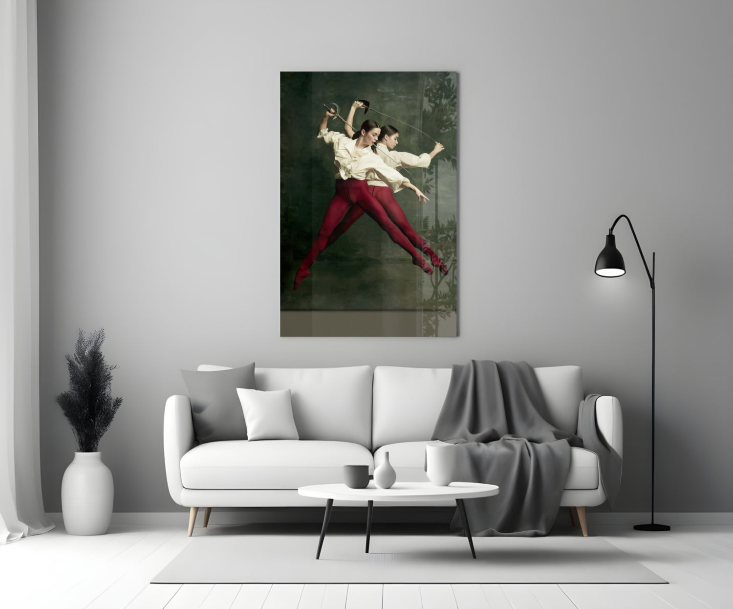 Glass wall art depicting two fencers in cream shirts and burgundy pants mid-lunge against a dark green background, displayed above a white sofa.