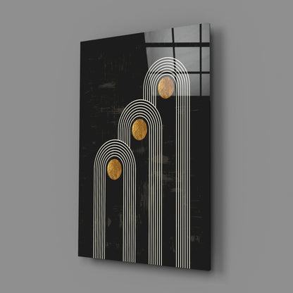 Three white-lined arches with gold oval centers on black glass panel, angled view showing depth and shadow.