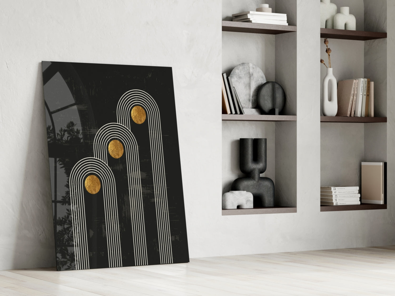 Black glass art print with white line arch patterns and gold circles, leaning against white wall beside wooden shelving unit.