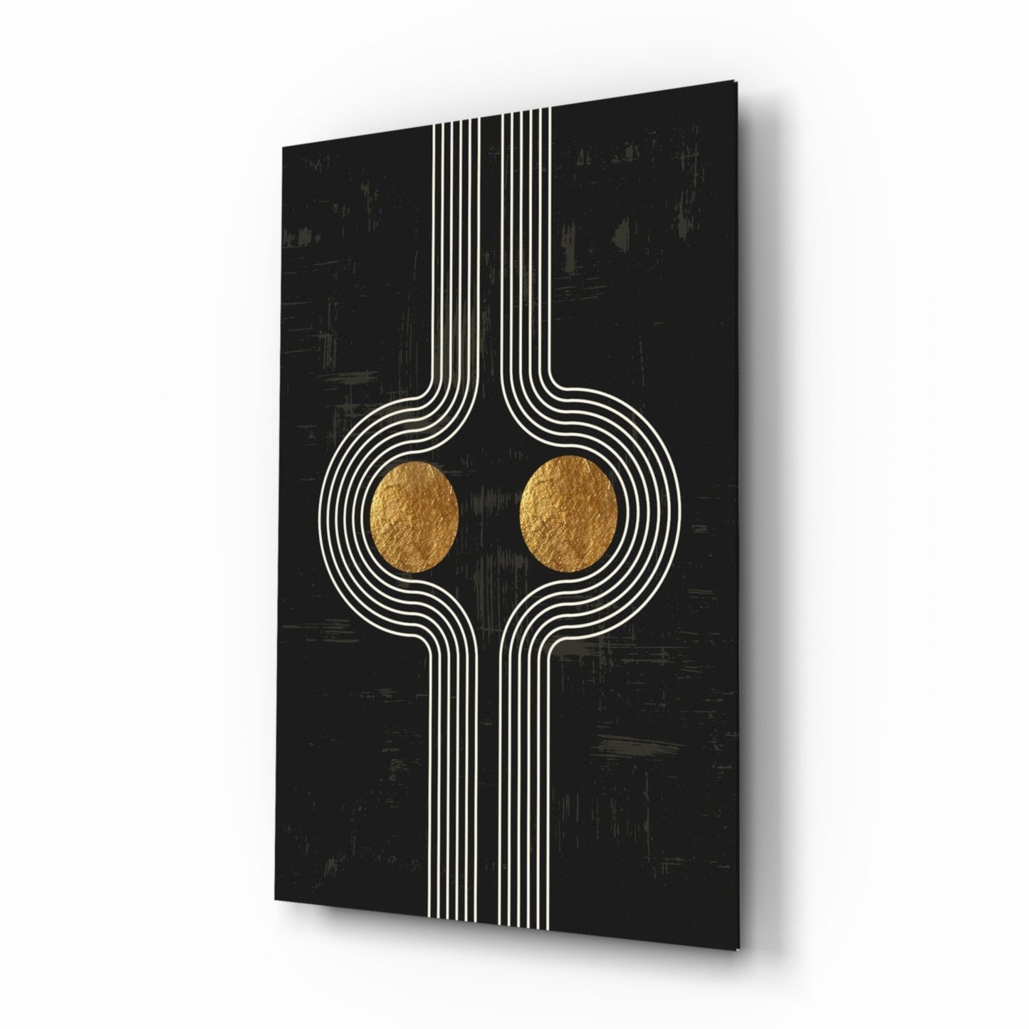 Modern glass wall art with symmetrical white linear design and two gold circular elements on black textured background, angled perspective view.
