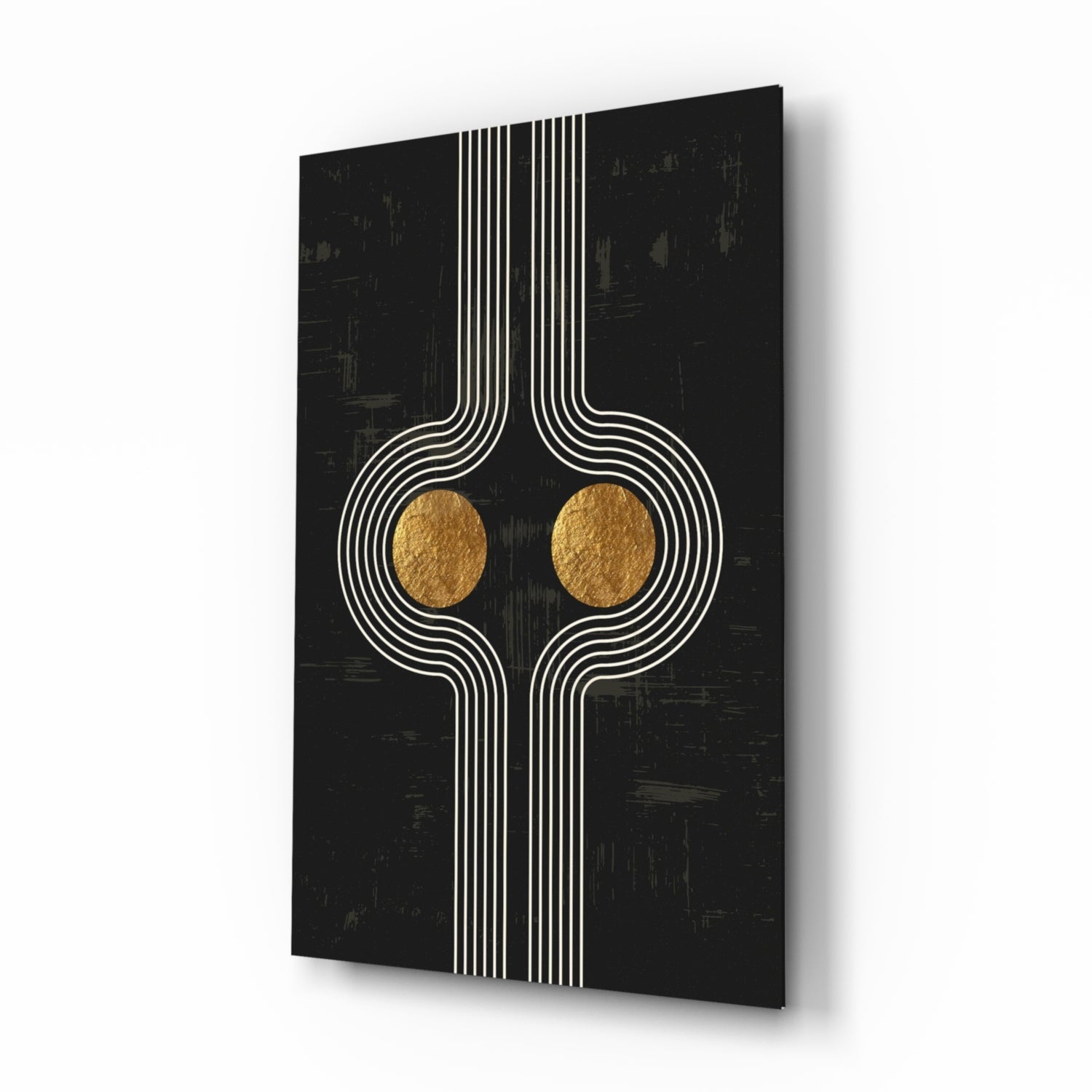 Modern glass wall art with symmetrical white linear design and two gold circular elements on black textured background, angled perspective view.
