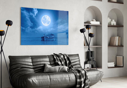 Moon and Boat Glass Wall Art displayed above gray leather sofa in modern living room with shelving.