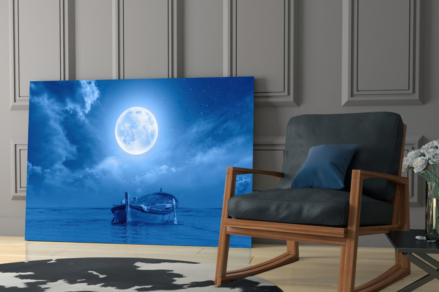 Moon and Boat glass wall art displayed in modern living room beside wooden chair with black cushions and potted flowers.