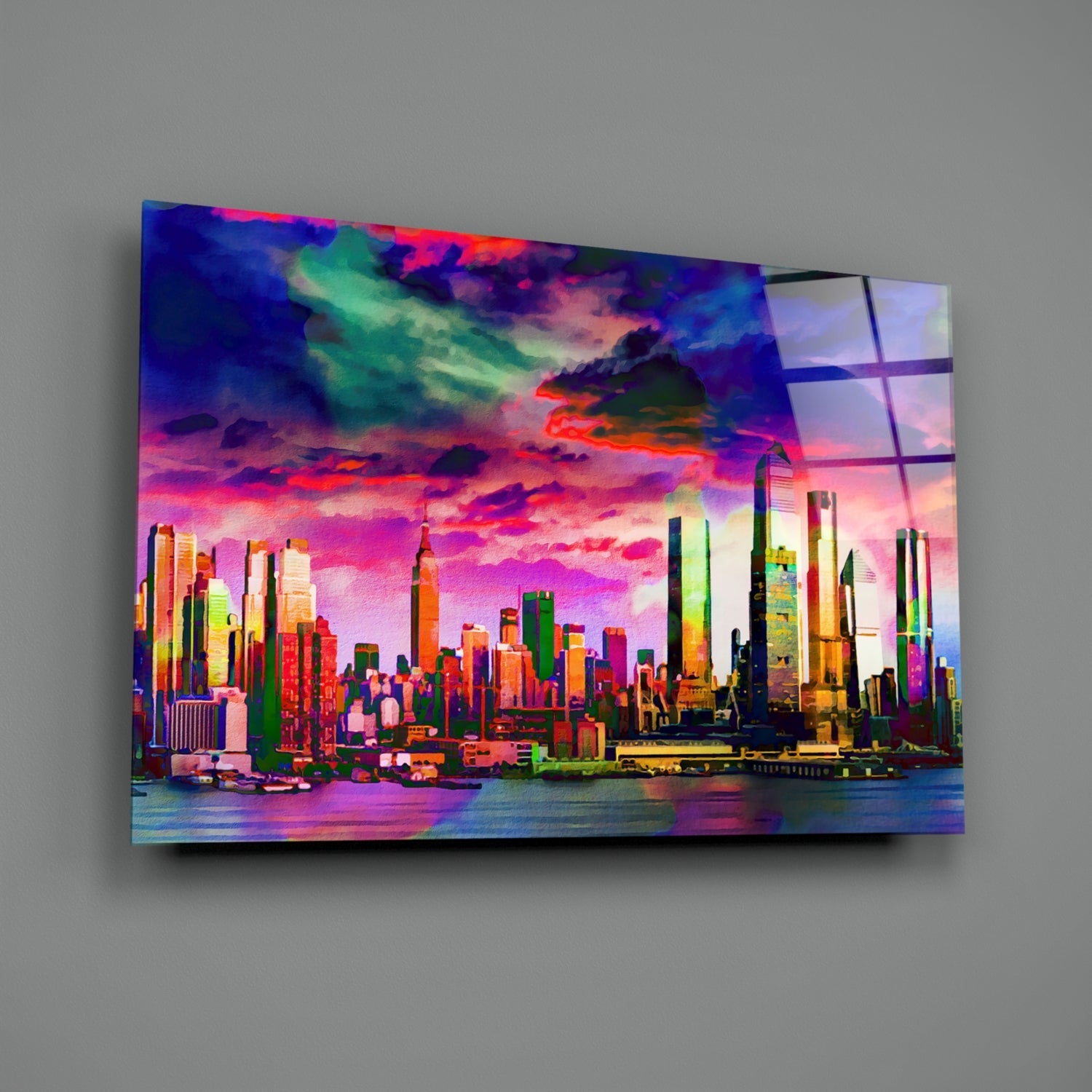 Vibrant neon-colored glass wall art displaying a colorful Manhattan skyline silhouette against a vivid sunset sky, mounted on gray wall.