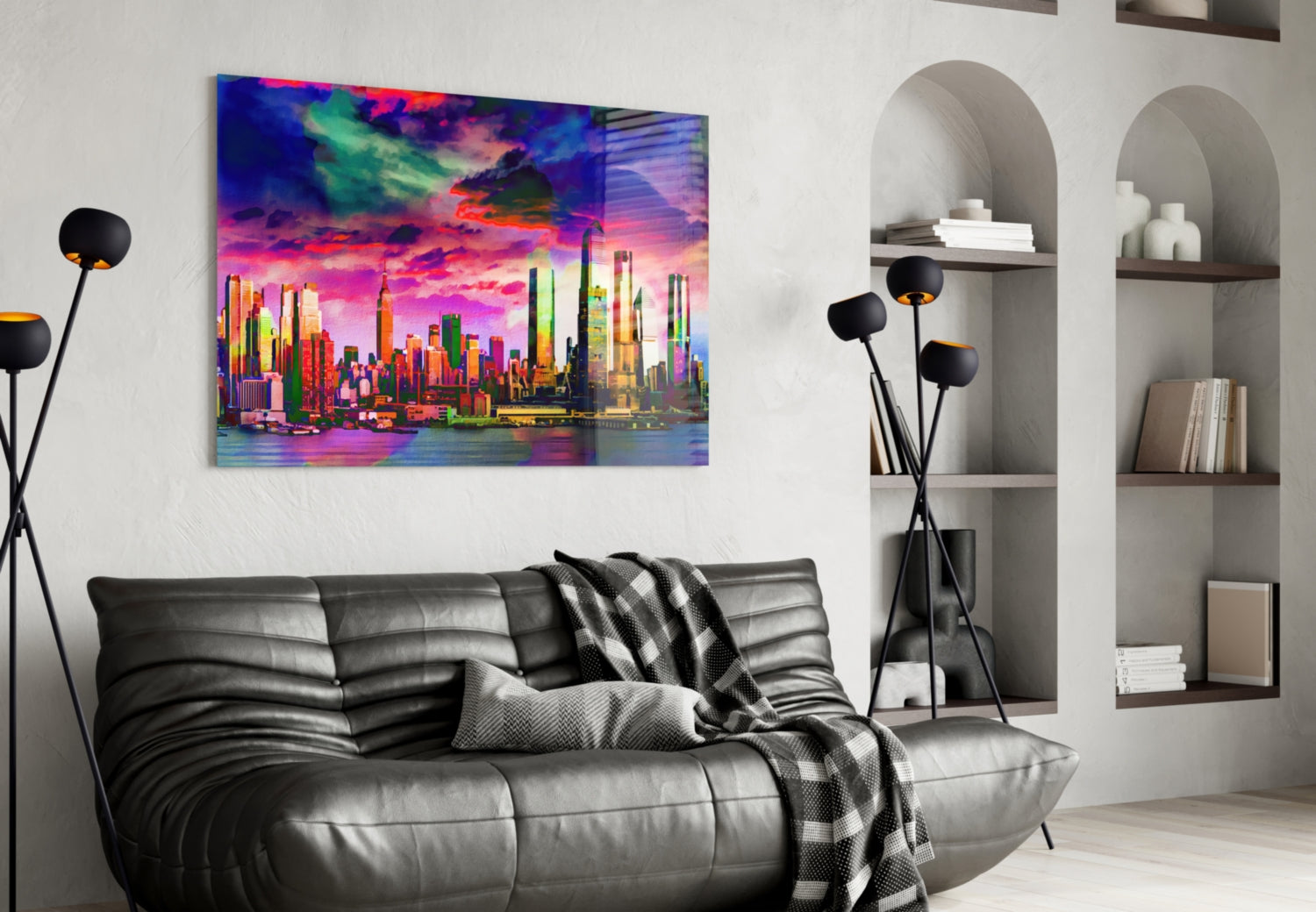 Vibrant neon cityscape glass art hung above black leather sofa in modern living room with white shelving.