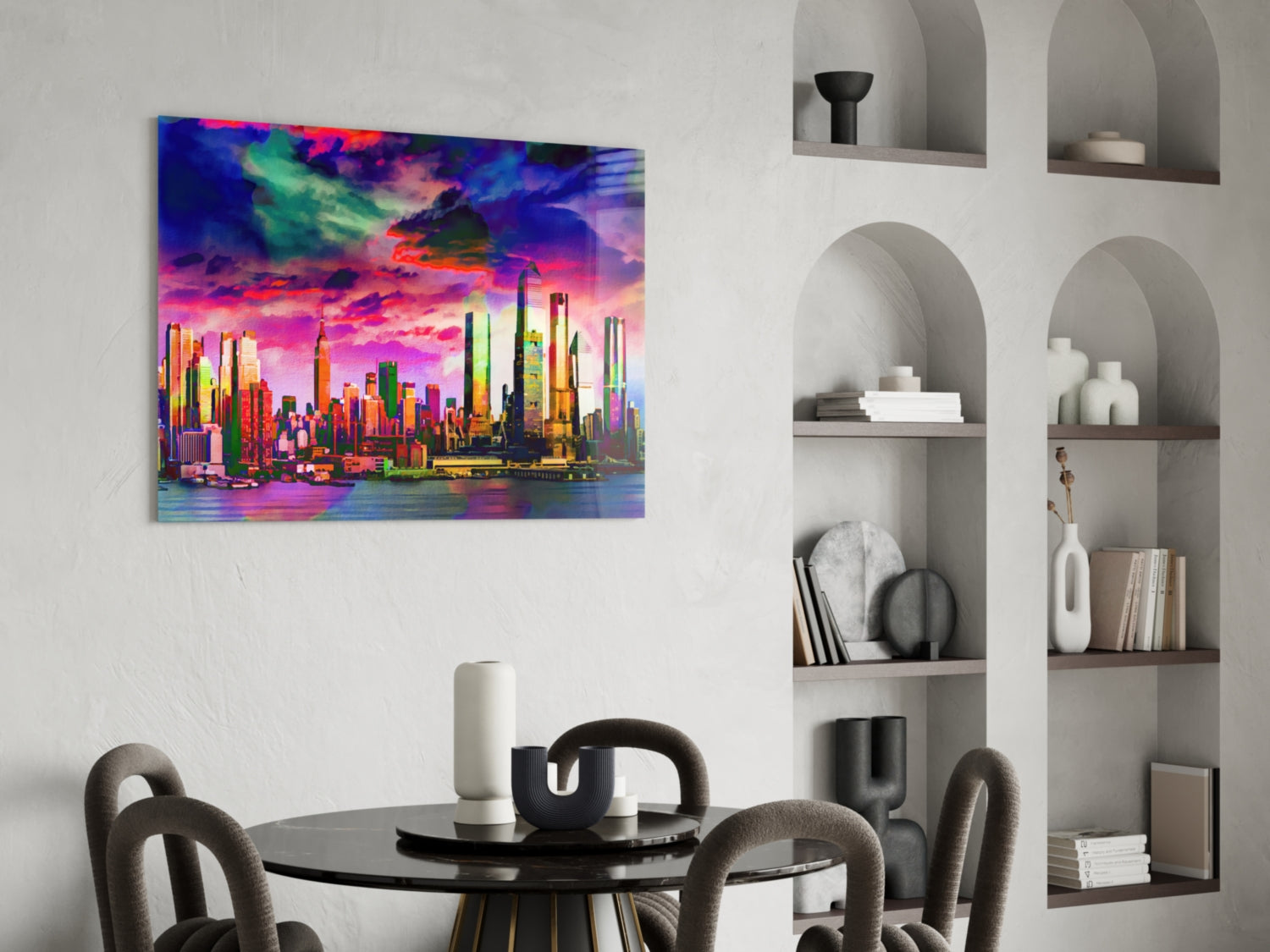 Vibrant neon-colored cityscape glass art hung above a round black dining table with gray chairs.