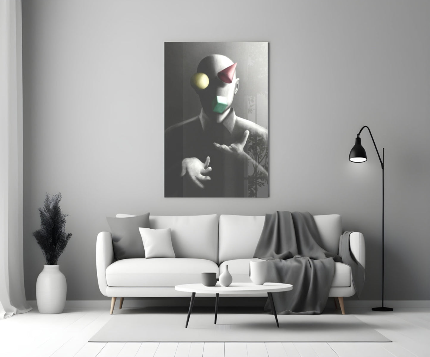 Juggler Glass Wall Art displayed above a white sofa in a minimalist living room setting with monochromatic decor.