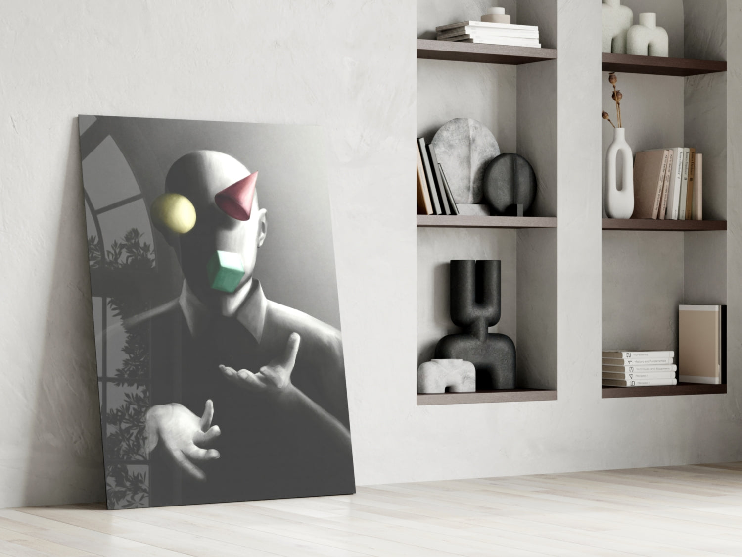 Juggler Glass Wall Art leaning against white wall beside shelving unit, displaying stylized figure with yellow and pink geometric shapes on gray background.