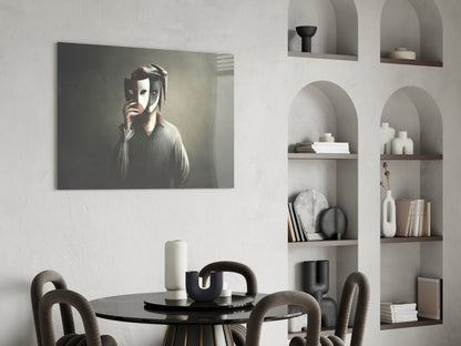 Glass wall art depicting a figure holding theatrical masks displayed above a black dining table in a minimalist interior setting.