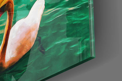Close-up side view of green glass wall art with white and orange painted pelican design against brushstroke background.