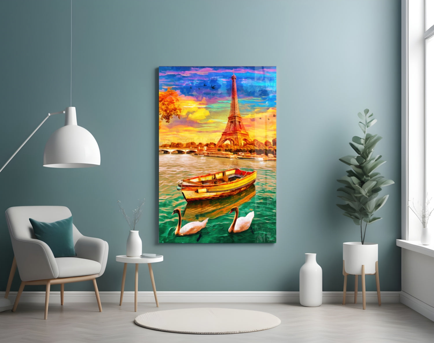 Colorful glass wall art depicting the Eiffel Tower at sunset with a boat and swans on water, displayed in a modern living room setting.