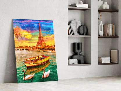 Colorful glass wall art leaning against white wall displays Eiffel Tower sunset scene with boat and swans in vibrant blues, yellows, and oranges.