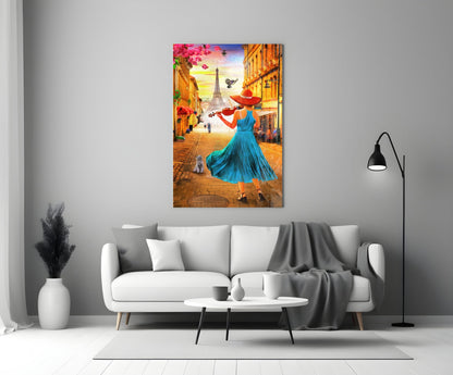 Colorful glass wall art depicting a woman in blue dress and red hat on a Paris street with Eiffel Tower, displayed above a white sofa.