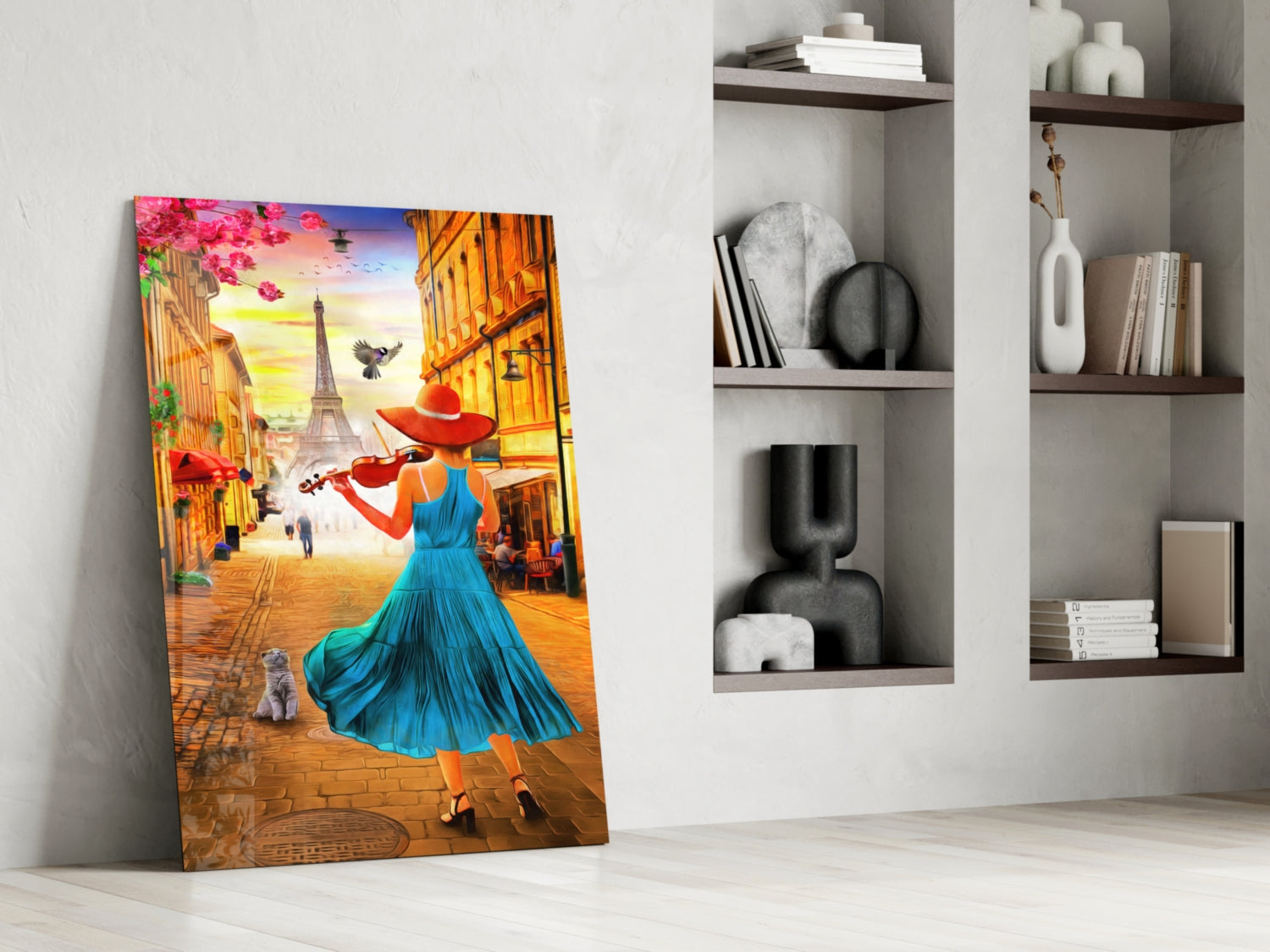 Colorful glass wall art leaning against white wall displays woman in blue dress with red hat playing violin on Paris street with Eiffel Tower.