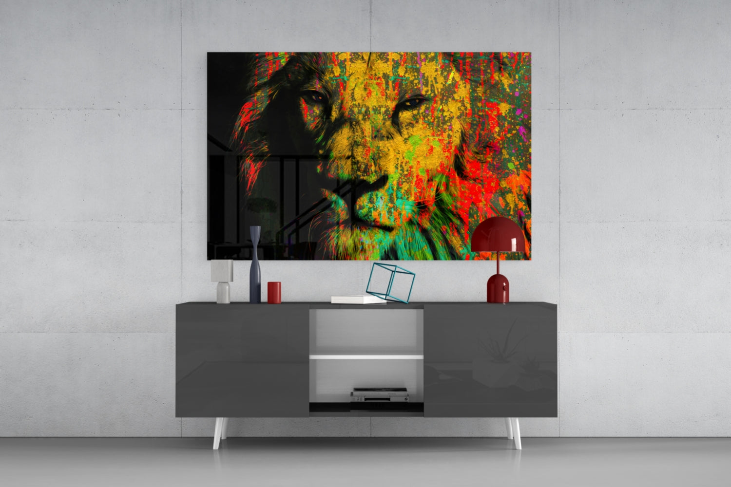 Colorful pop art lion head glass wall art displaying vibrant reds, yellows, greens, and blues mounted above gray media console in modern interior setting.
