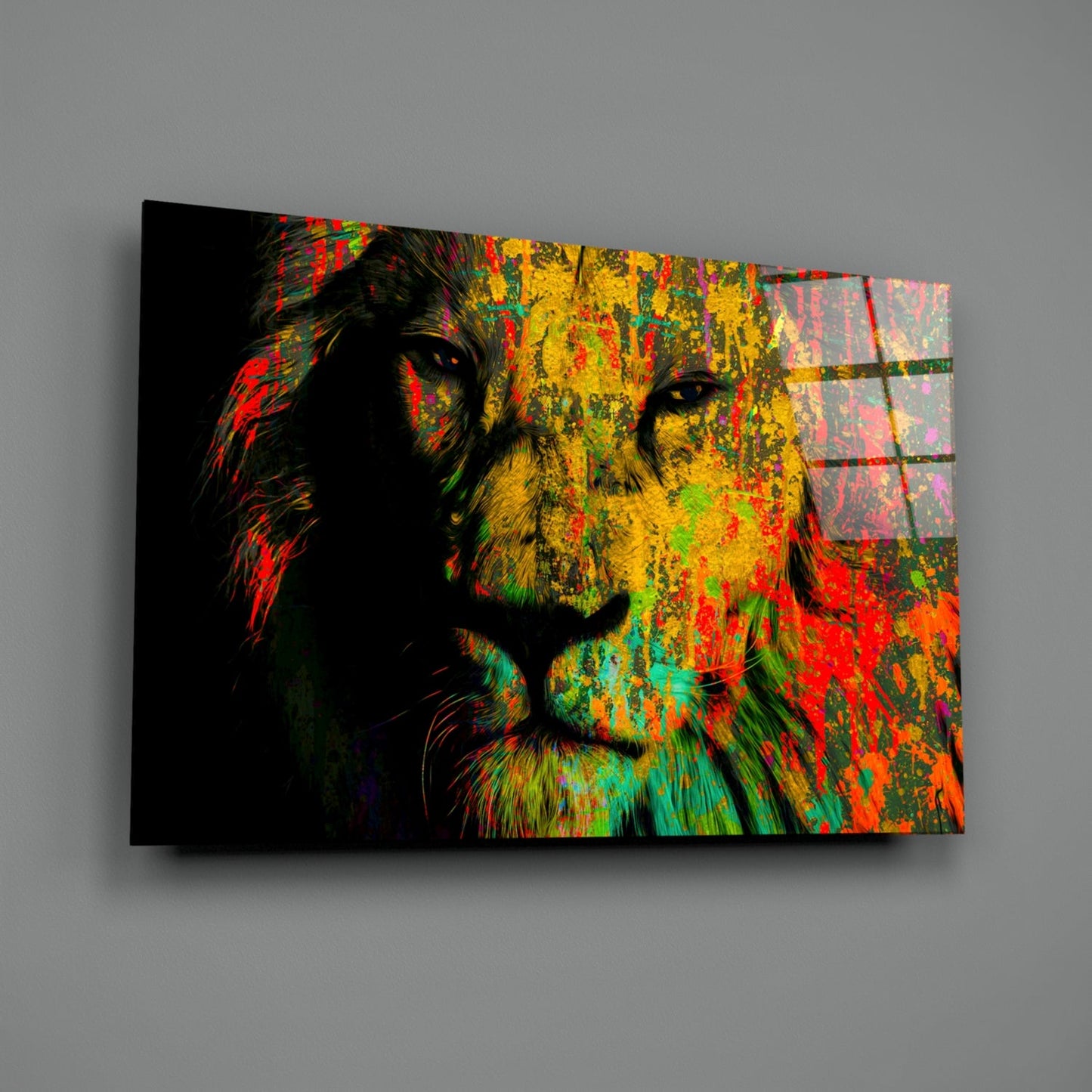Colorful glass wall art featuring a lion's profile with vibrant yellow, red, green, and orange paint splatters on black background, angled perspective.