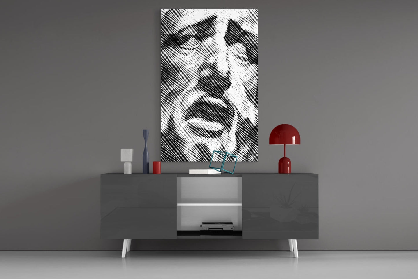 Black and white wavy striped glass wall art displayed above gray media console with red lamp and decorative objects.