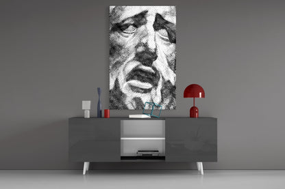 Black and white wavy striped glass wall art displayed above gray media console with red lamp and decorative objects.