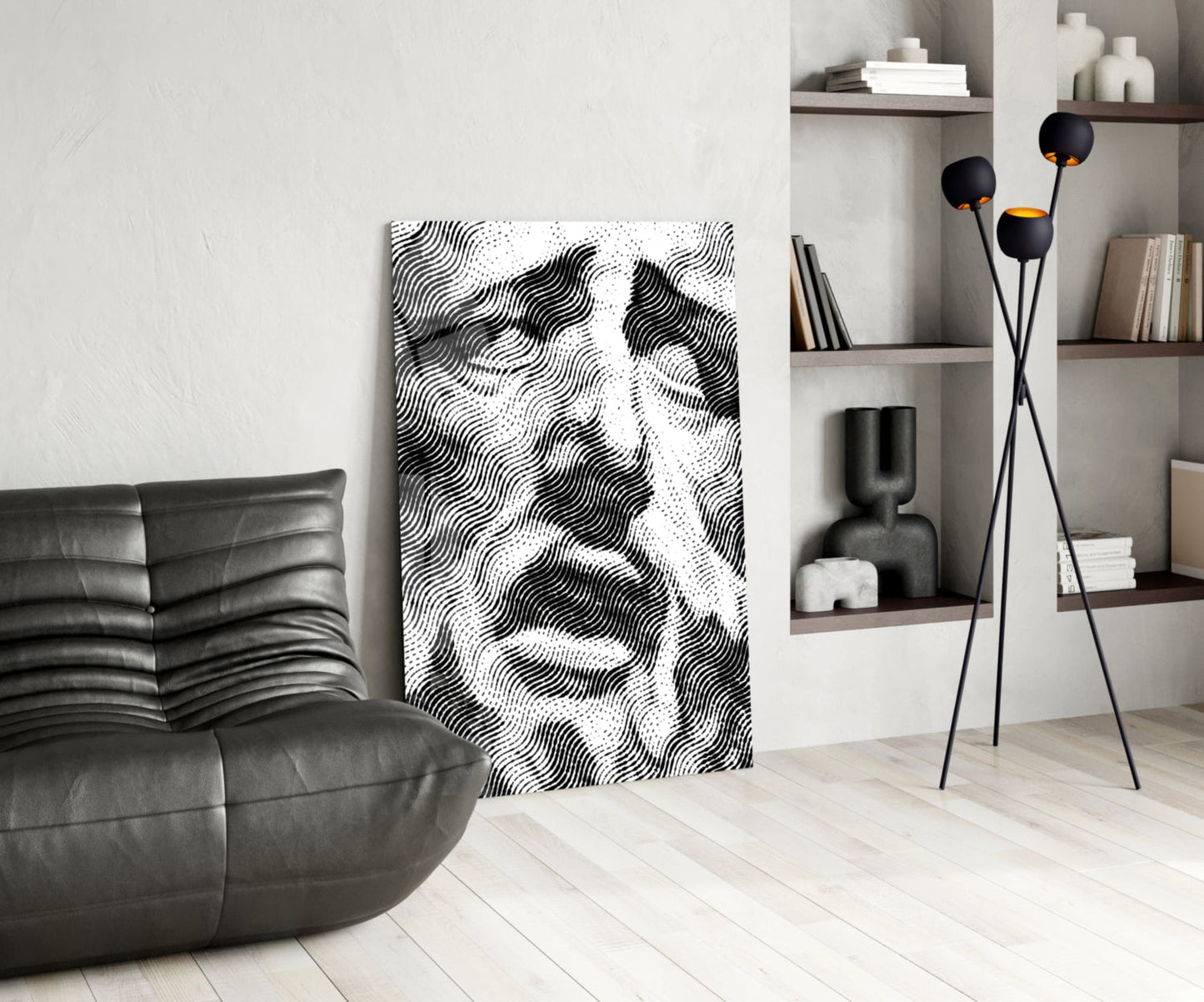 Modern living room interior featuring black and white wavy patterned glass wall art leaning against white wall beside leather chair.