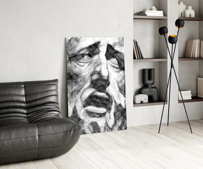 Modern living room interior featuring black and white wavy patterned glass wall art leaning against white wall beside leather chair.