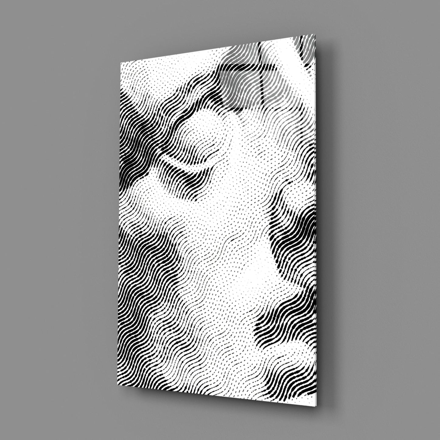 Angled perspective view of white glass wall art with black wavy line pattern and dotted texture against gray background.
