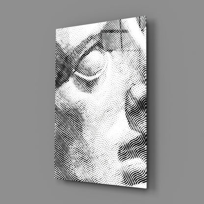 Angled perspective view of white glass wall art with black wavy line pattern and dotted texture against gray background.